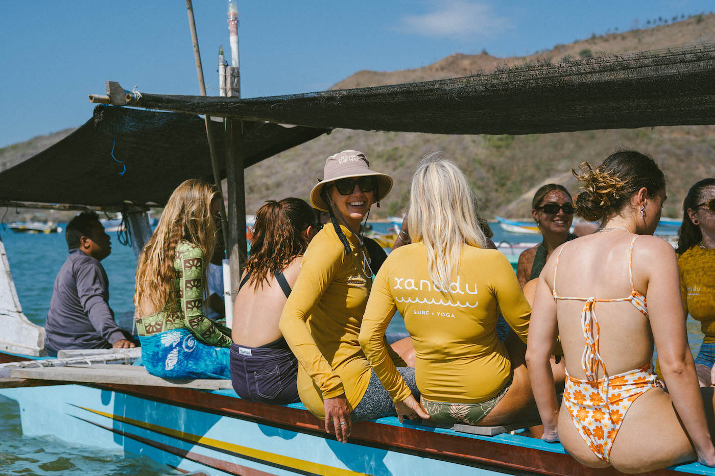 Women on their way out to the surf on a boat at Xanadu surf and yoga retreat